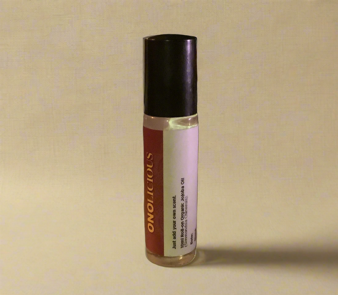 Small glass bottle with a black cap on a white background